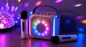 Mini karaoke machine with colorful LED lights and two wireless microphones ready for home parties and family singing.
